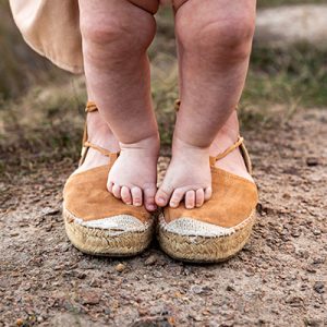 baby feet on mothers feet