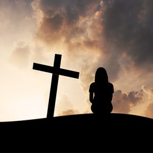 woman beside cross