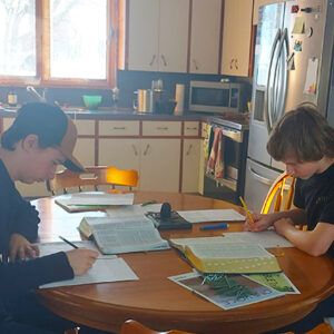 boys doing learning work at the kitchen table
