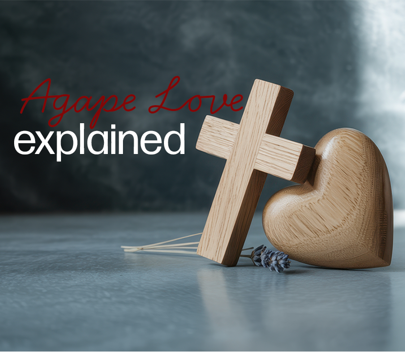 wooden cross leaning on wooden heart "Agape Love explained"
